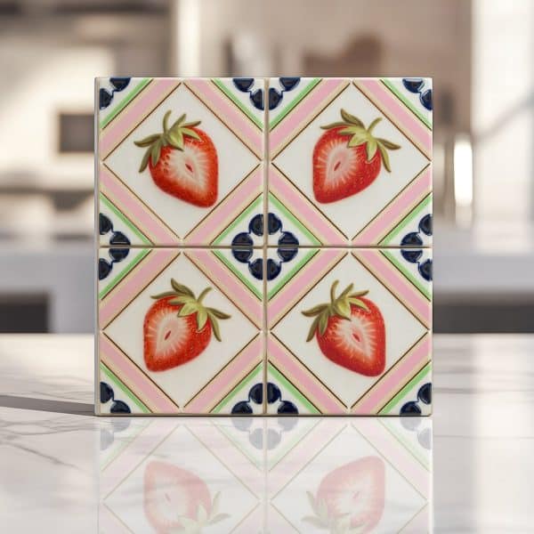 Tile Featuring Four Strawberries On A Pink And Green Geometric Pattern.