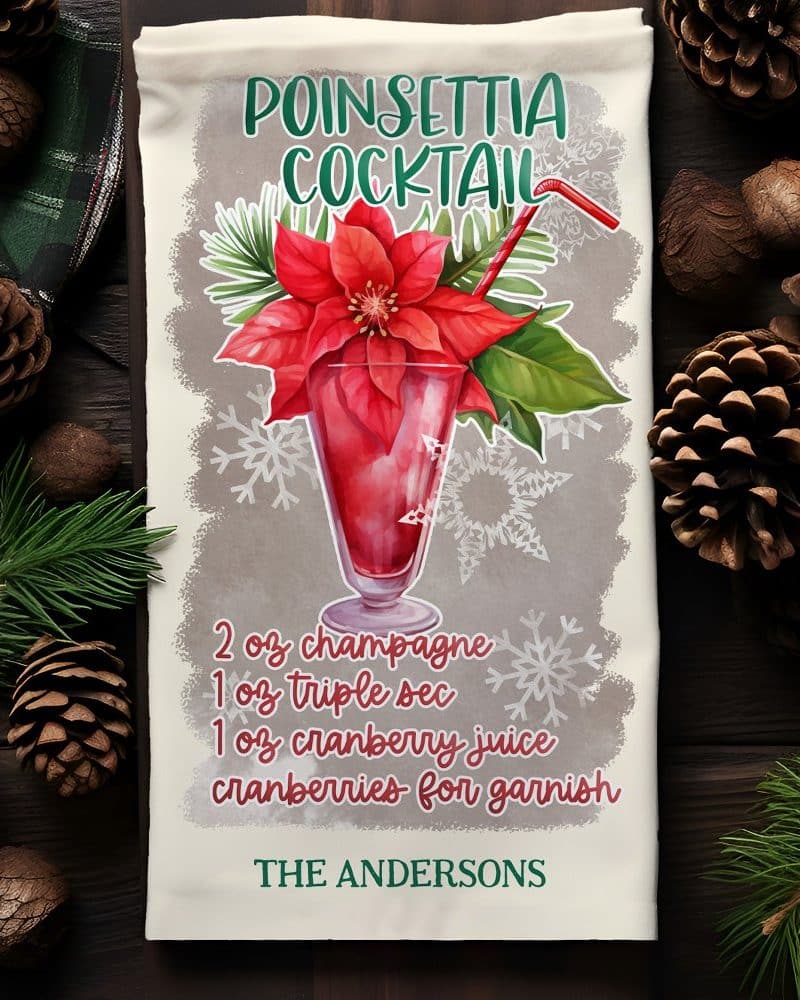 Poinsettia cocktail recipe on a kitchen towel, featuring a watercolor illustration of a drink garnished with a poinsettia.