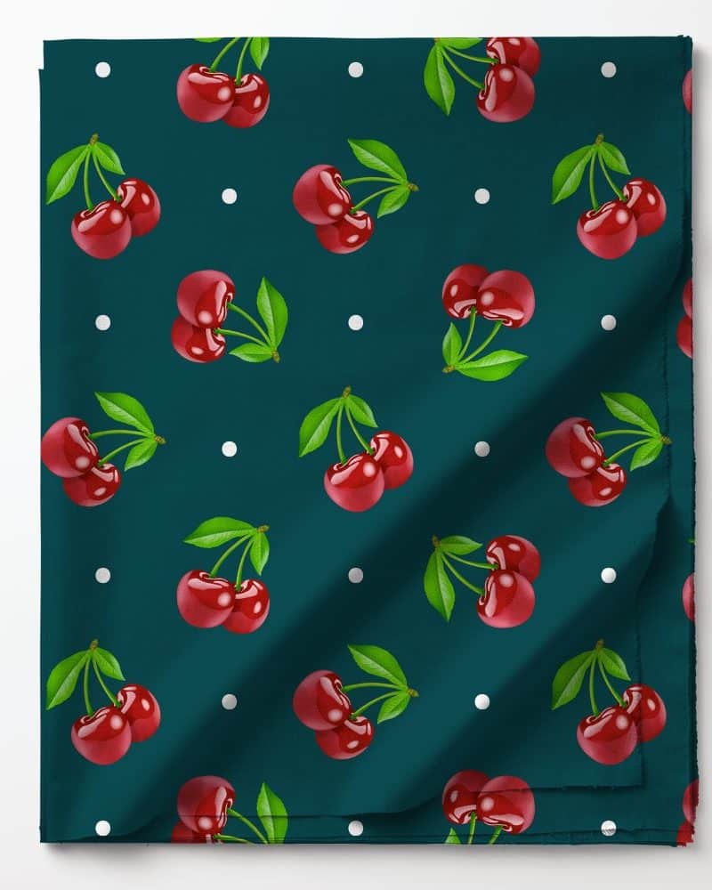 Teal fabric with a repeating pattern of red cherries and white polka dots.