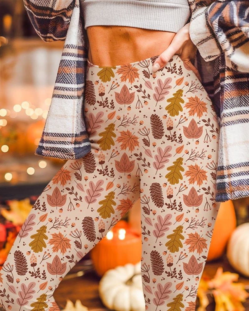 Beige leggings with an autumn leaf and pine cone pattern.