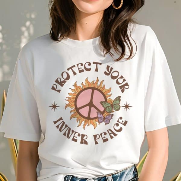 Woman Wearing A White T-Shirt With A Peace Symbol In A Sun Design And The Text Protect Your Inner Peace.