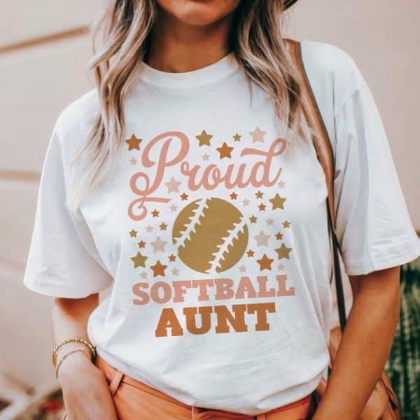 White T-Shirt With A Softball Graphic And The Text Proud Softball Aunt.