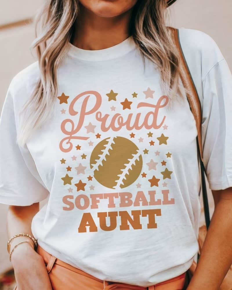 White t-shirt with a softball graphic and the text Proud Softball Aunt.