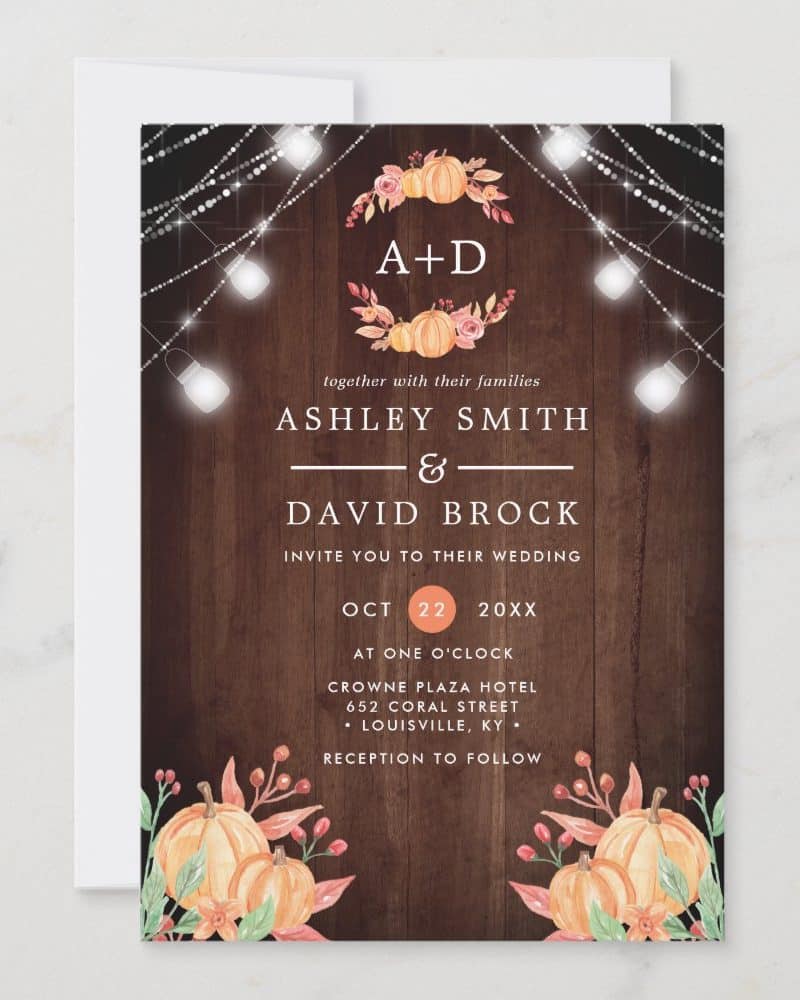 Fall-themed wedding invitation with pumpkins, string lights, and the couple's names.