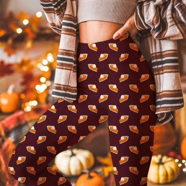 Person Wearing Maroon Leggings Patterned With Repeated Images Of Pumpkin Pie Slices.
