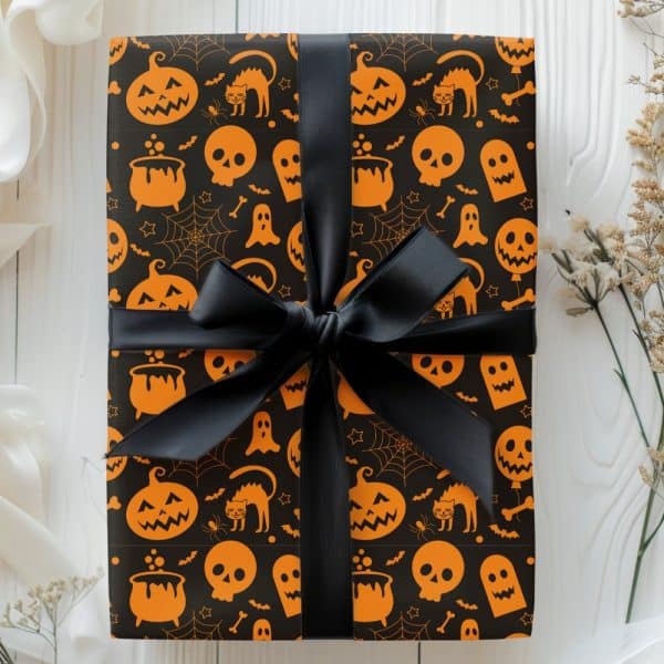Halloween Gift Wrapped In Black Paper With An Orange Pattern Of Pumpkins, Skulls, And Other Halloween Icons, Tied With A Black Ribbon.