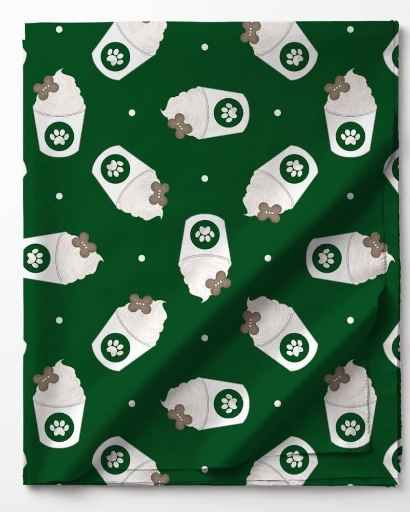 Green fabric with a repeating pattern of frothy coffee cups decorated with paw prints.