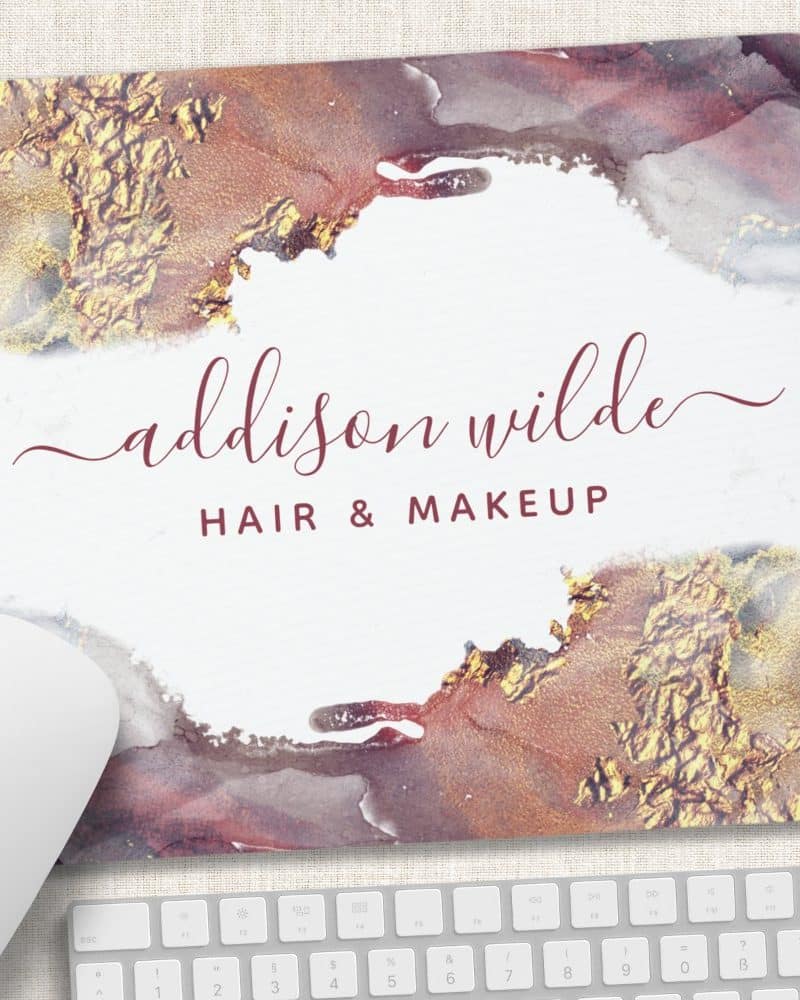 Mousepad with Addison Wilde Hair & Makeup logo; maroon text on a white background with gold and burgundy abstract watercolor design.
