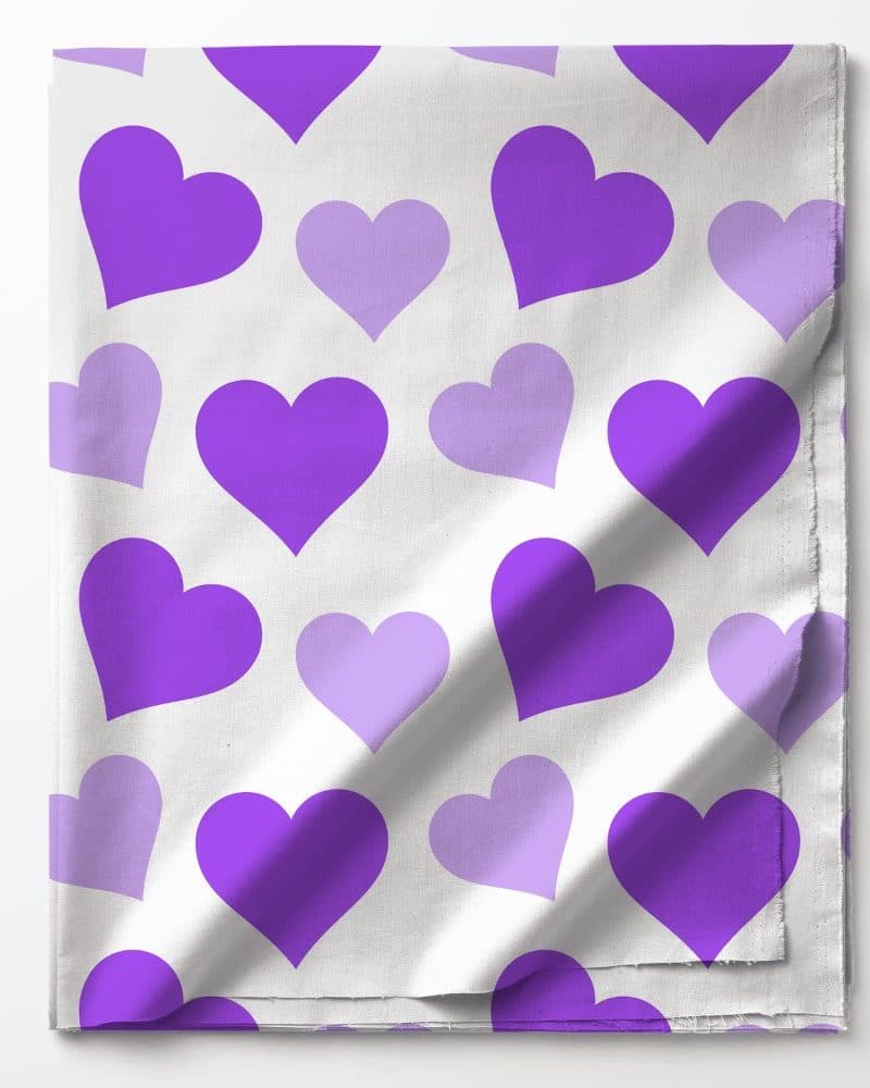 Purple and light purple hearts on white fabric.
