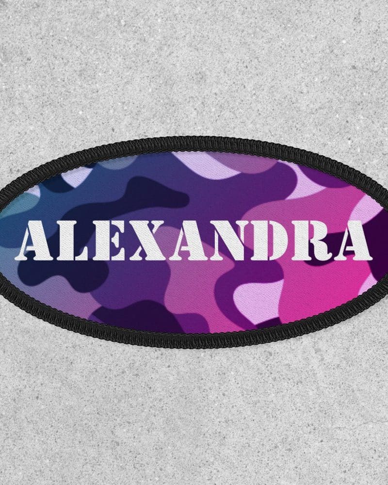 Oval purple and pink camouflage patch with the name Alexandra in white lettering.