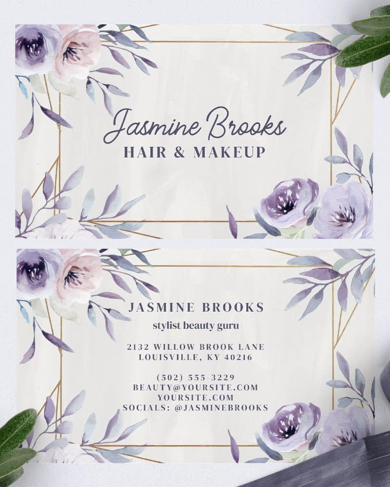 Two elegant business cards for Jasmine Brooks, hair and makeup stylist, featuring watercolor floral designs in shades of purple and gold geometric accents.