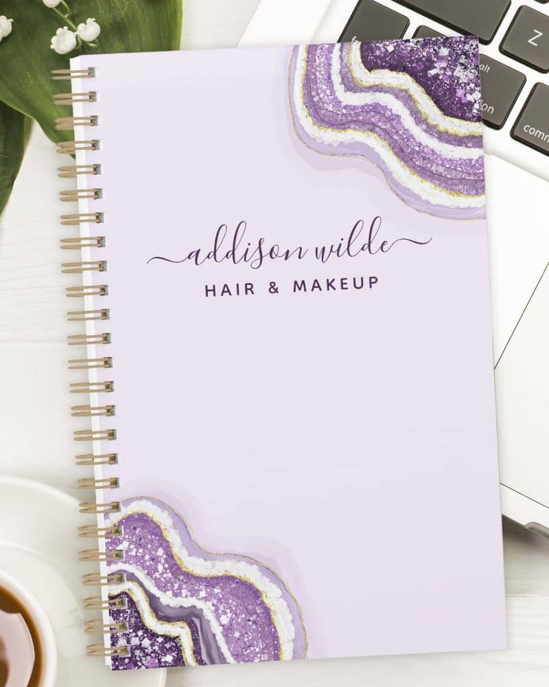 Lavender spiral notebook with gold and purple agate design and Addison Wilde Hair & Makeup text.