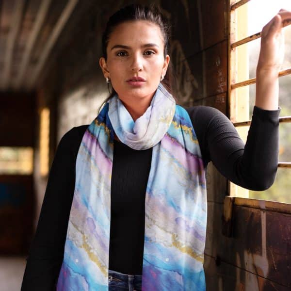 Woman Wearing A Long, Light Blue And Purple Watercolor-Patterned Scarf.