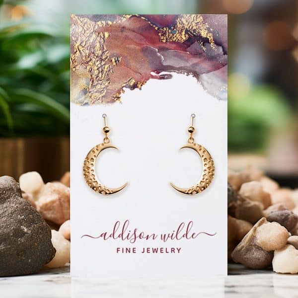 Gold Crescent Moon Earrings Displayed On A Card.
