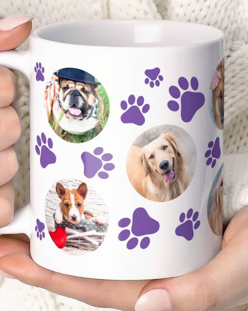White coffee mug featuring multiple dog photos and purple paw prints.