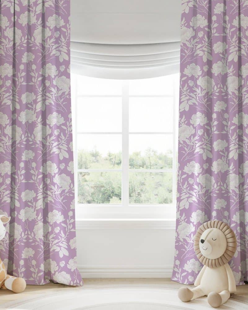 Lavender curtains with a white floral pattern hang on a window.