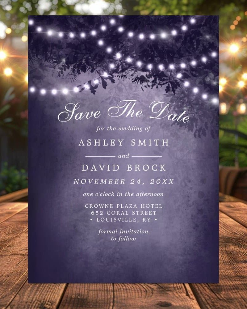 Purple save the date card with string lights and foliage, announcing Ashley Smith and David Brock's wedding on November 24.