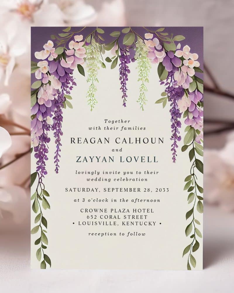 Wedding invitation with purple wisteria floral border.