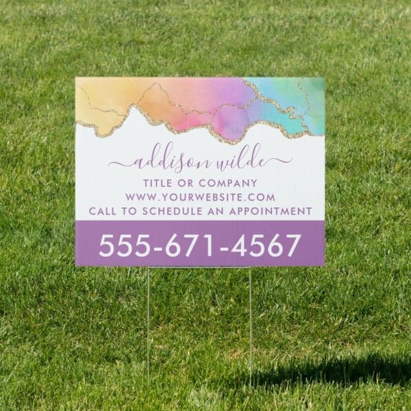 Yard Sign With A Pastel Watercolor Design, Displaying Addison Wilde'S Name, Website, And Phone Number.