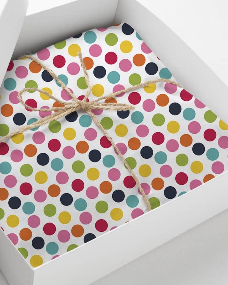 Gift box with colorful polka dot wrapping paper tied with twine.