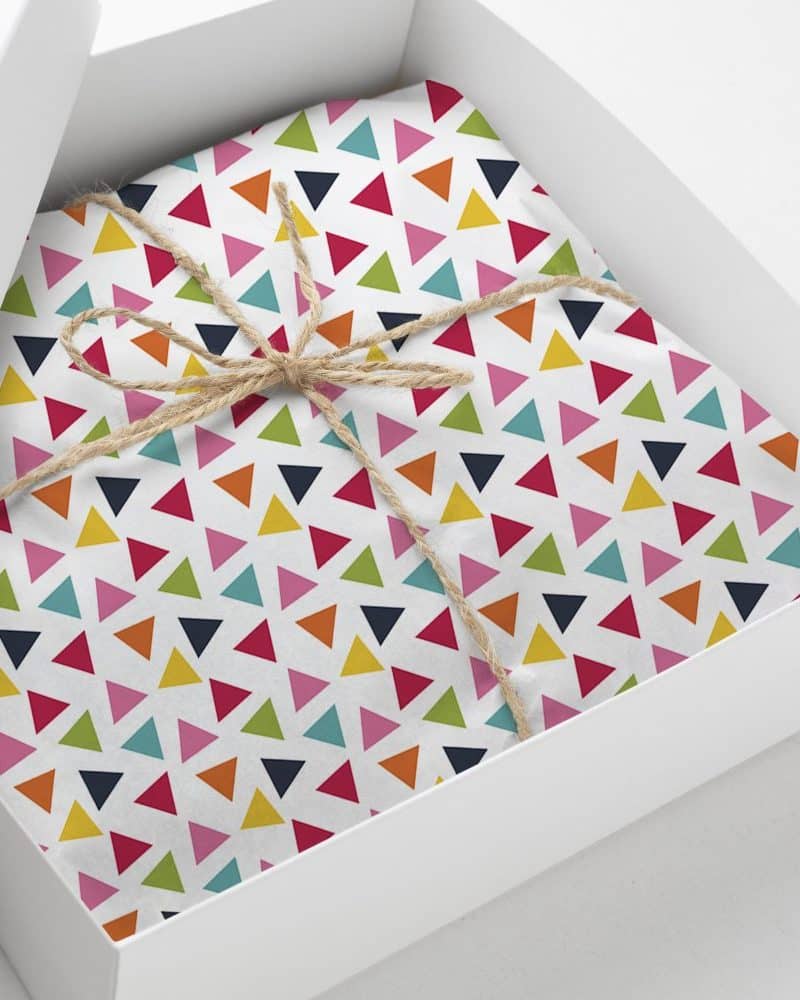 Gift box with colorful triangle patterned wrapping paper tied with twine.