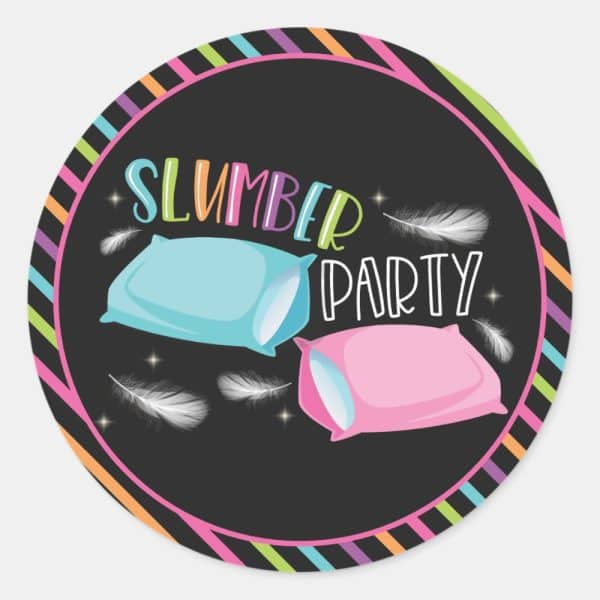 Slumber Party Invitation Featuring Two Pillows And Feathers On A Dark Background With A Colorful Striped Border.