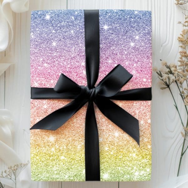 A Gift Wrapped In Rainbow Glitter Paper With A Black Ribbon.
