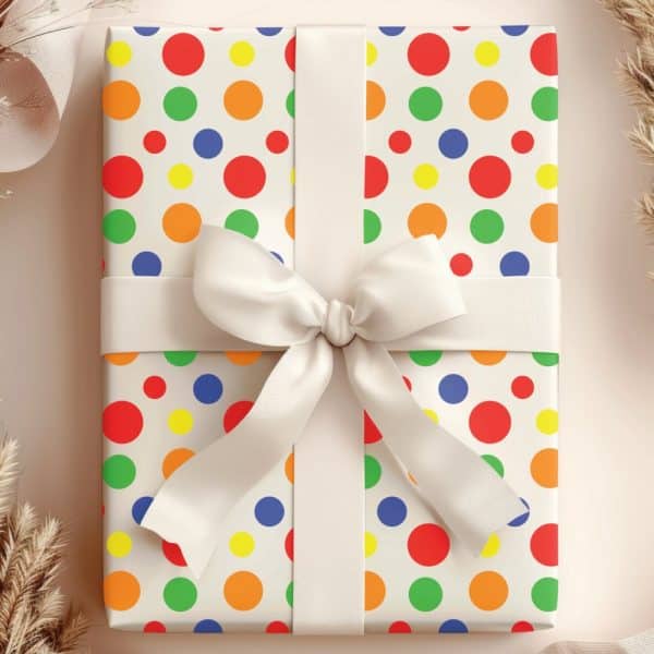 A Gift Wrapped In Off-White Paper With A Colorful Polka Dot Pattern And A Cream-Colored Ribbon.
