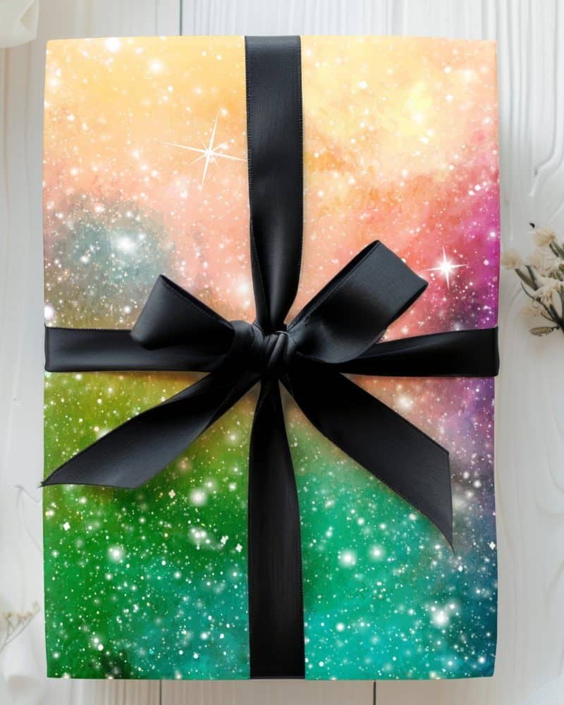 Gift box with a nebula-patterned design and black ribbon.