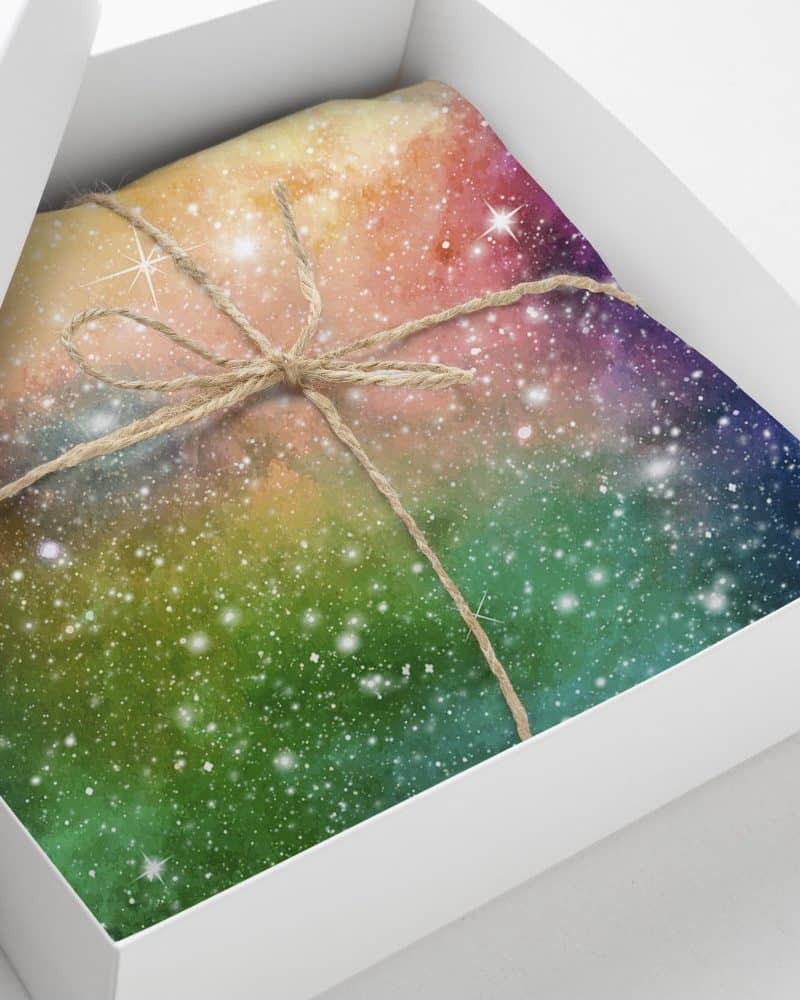 A gift box containing a galaxy-patterned item tied with twine.