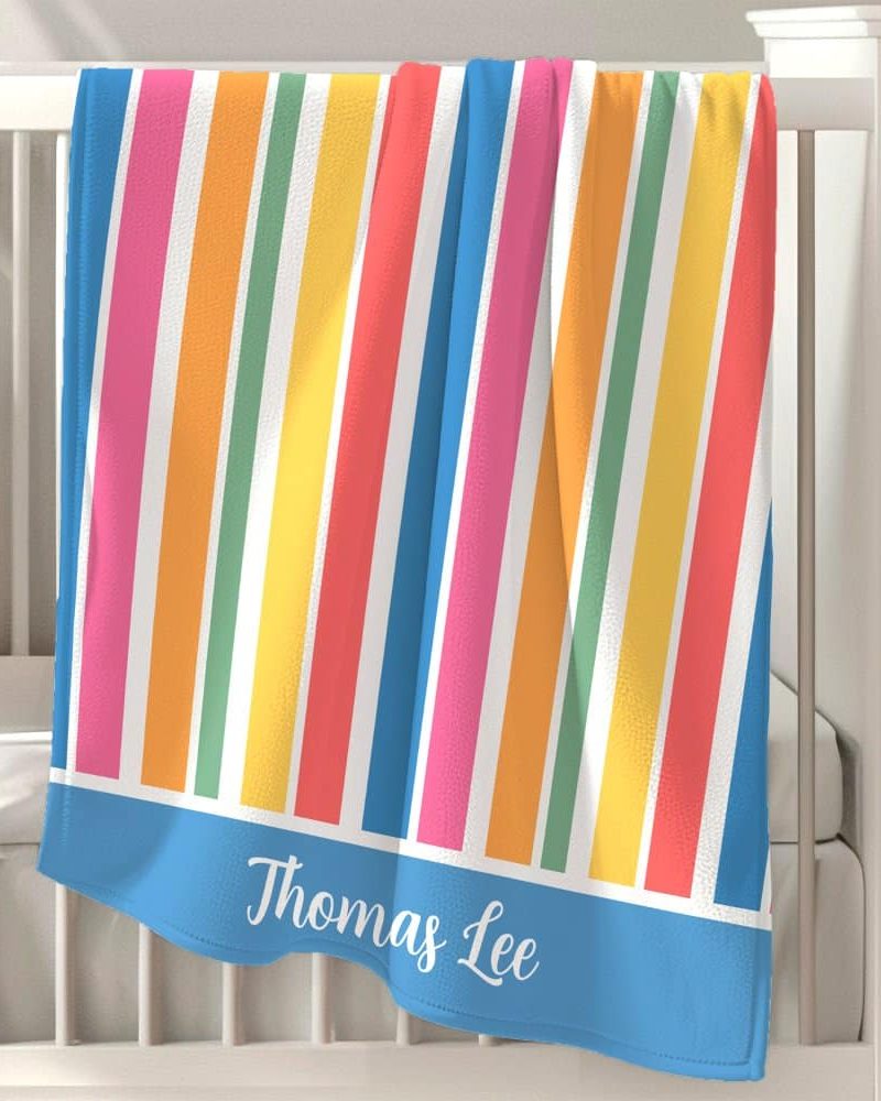 Personalized baby blanket with multicolored vertical stripes and the name Thomas Lee.