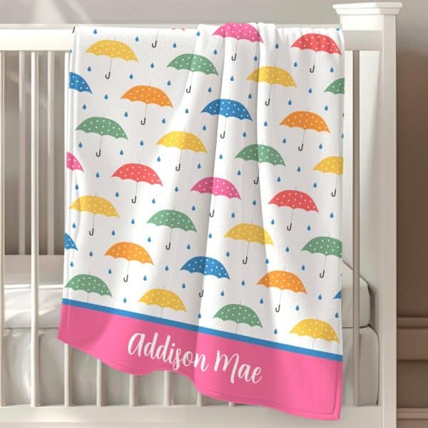 Personalized Baby Blanket With A Colorful Polka Dot Umbrella Pattern And The Name Addison Mae.