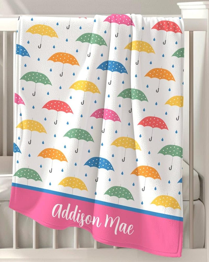 Personalized baby blanket with a colorful polka dot umbrella pattern and the name Addison Mae.