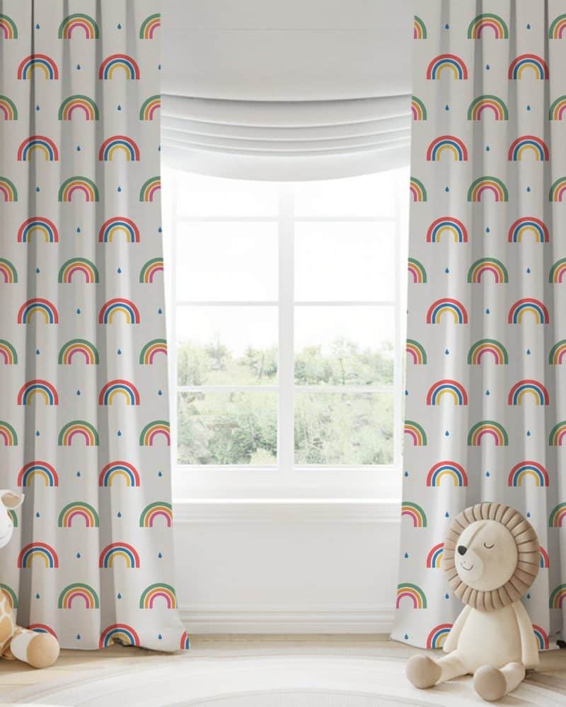 Pair of children's curtains featuring a multicolored rainbow pattern on a light background.