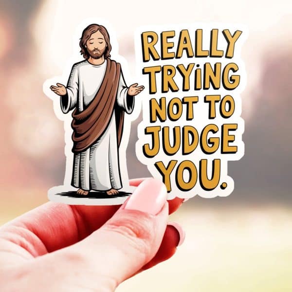 Hand Holding Sticker Of Jesus With Text: Really Trying Not To Judge You.