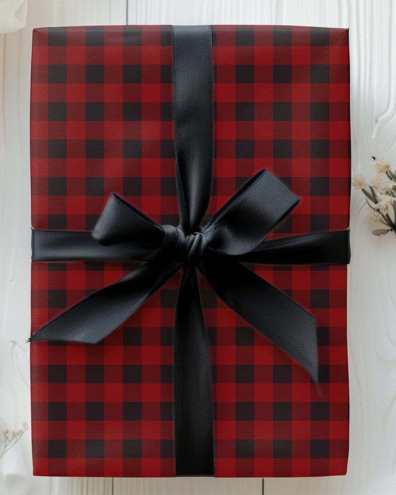 Red and black buffalo plaid gift box tied with a black ribbon.