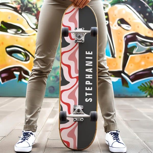 Person Holding A Personalized Skateboard With A Pink And Black Abstract Design And The Name Stephanie.