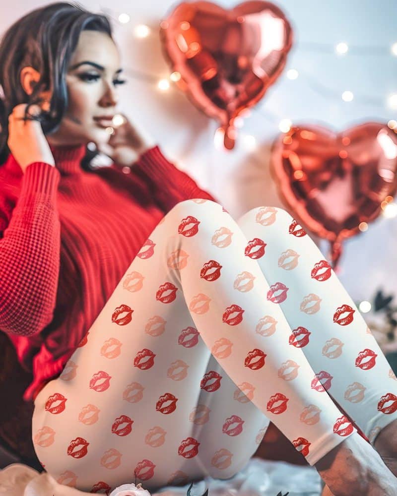 Woman in red sweater wearing off-white leggings patterned with red and pink lips.
