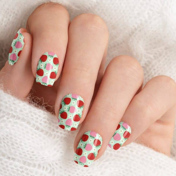 Close-Up Of A Hand With Fingernails Decorated With A Strawberry Pattern.