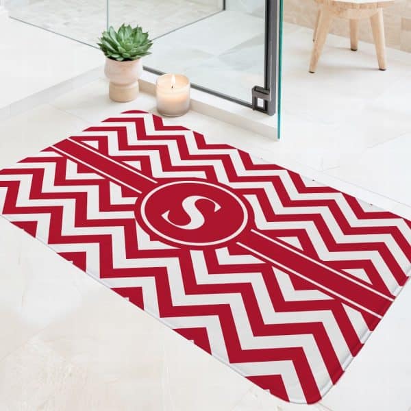 Red And White Chevron Bath Mat With A Monogrammed Letter S.