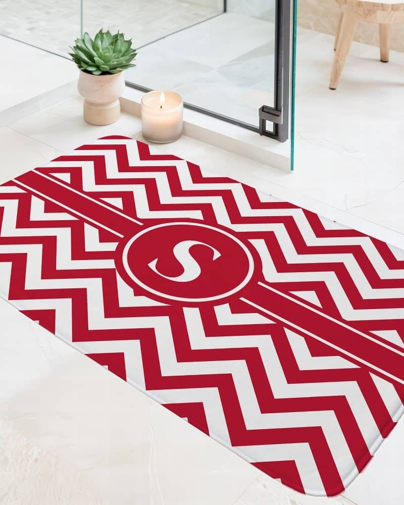 Red and white chevron bath mat with a monogrammed letter S.