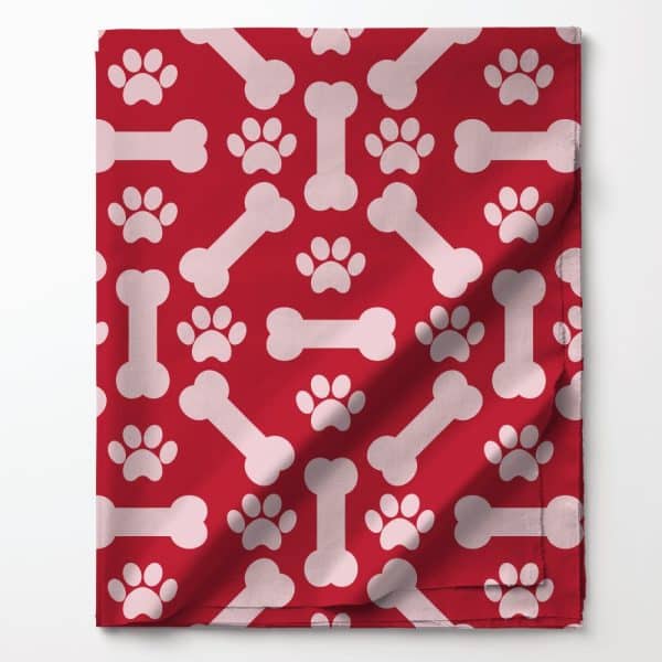 Red Fabric With A Repeating Pattern Of Pink Bones And Paw Prints.