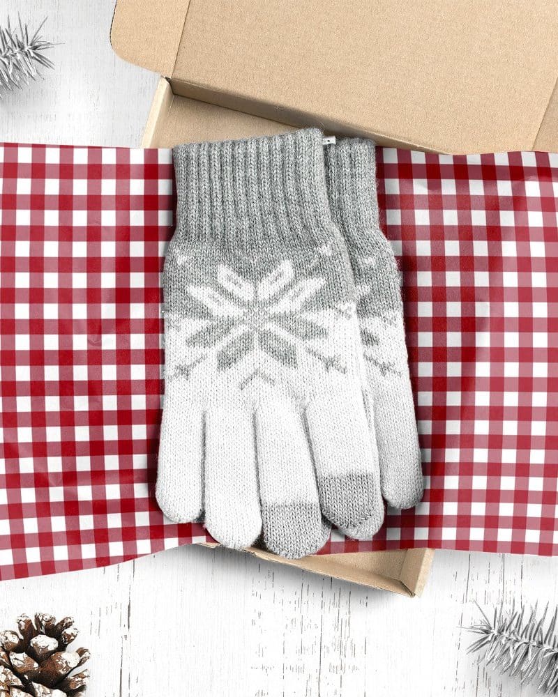 Pair of gray and white snowflake patterned gloves in a gift box.