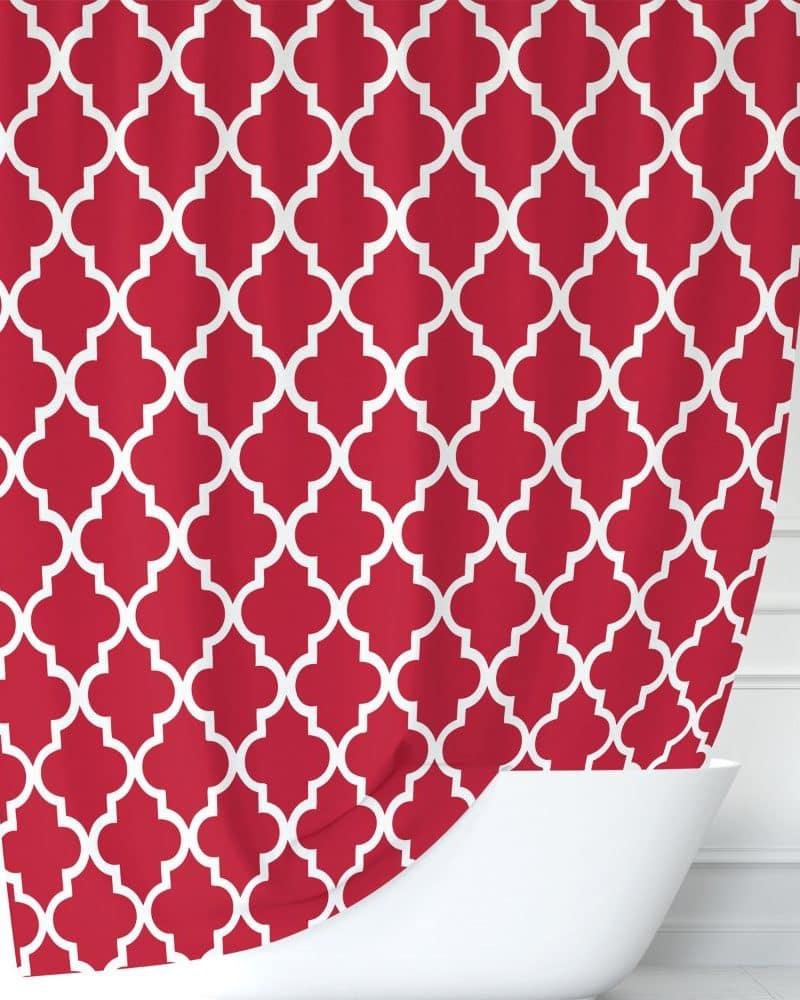 Red shower curtain with a white quatrefoil pattern.