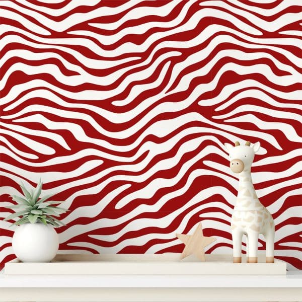 White And Red Zebra Striped Wall With A Small Giraffe Figurine And Plant.