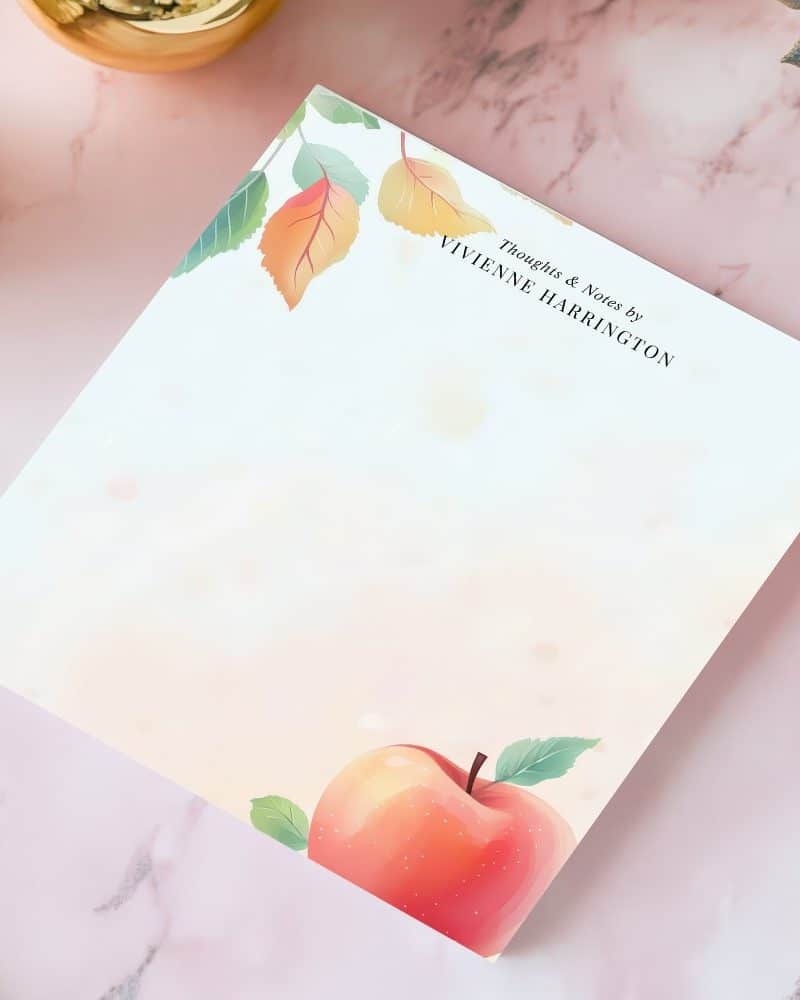 Blank stationery featuring an illustration of an apple and autumn leaves in the corner. The top right corner includes the text Thoughts & Notes by Vivienne Harrington.