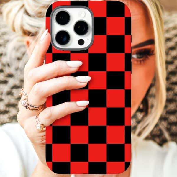 A Woman'S Hand Holds A Red And Black Checkered Iphone Case In Front Of Her Face.