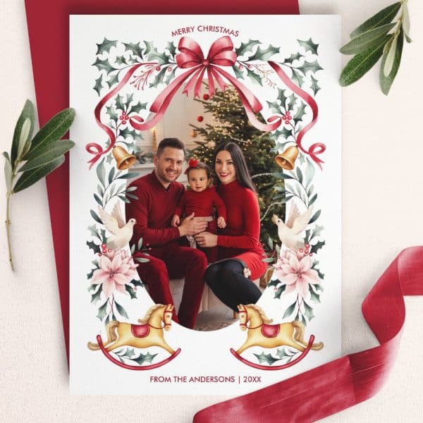 Christmas Family Photo Card Featuring The Andersons, Parents And Young Child, Framed By A Festive Wreath With Ribbons, Doves, And Rocking Horses.