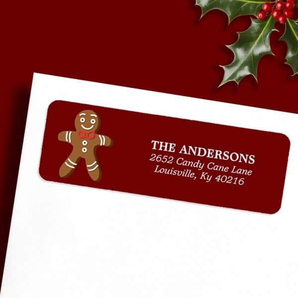A Dark Red Return Address Label With A Gingerbread Man And The Address The Andersons, 2652 Candy Cane Lane, Louisville, Ky 40216.