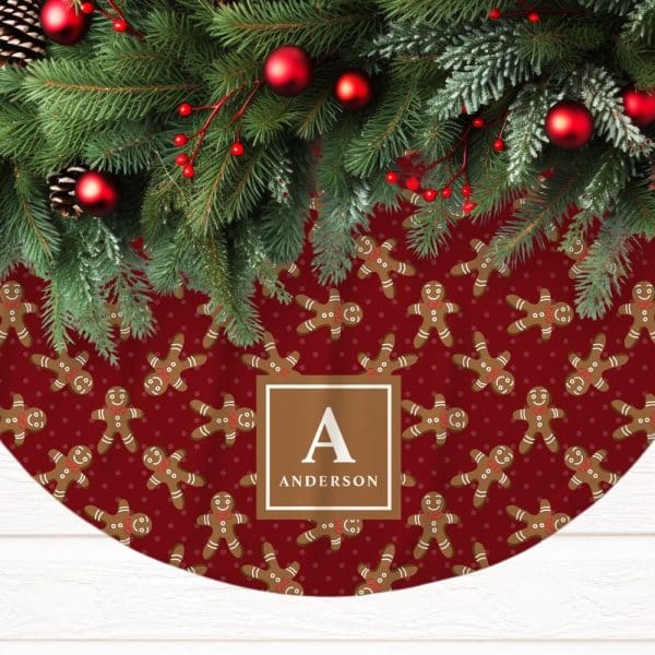 A Red Christmas Tree Skirt With A Repeating Pattern Of Gingerbread Men And The Personalized Name Anderson.